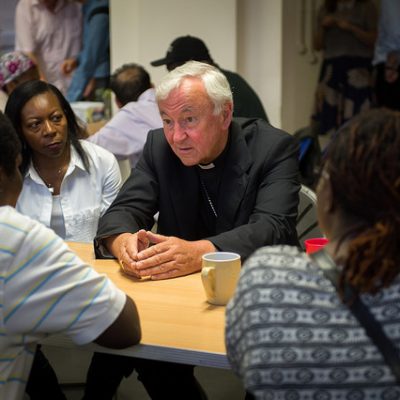 Cardinal Vincent Nichols spends time with refugees accompanied by JRS