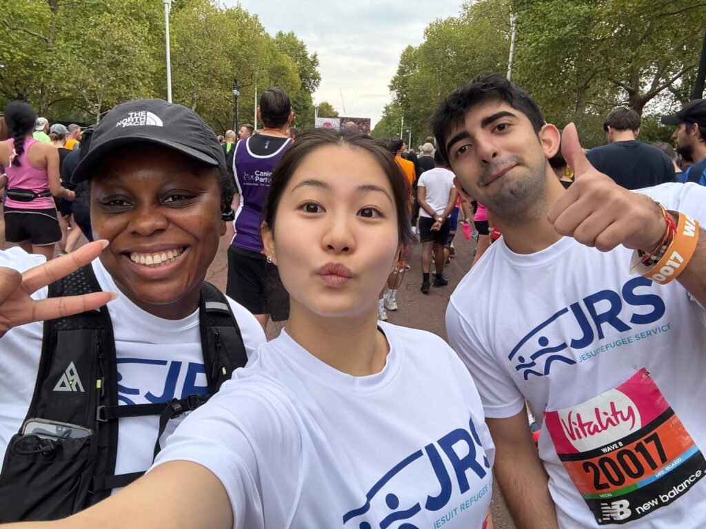 Three Team JRS runners pose for a selfie at a race
